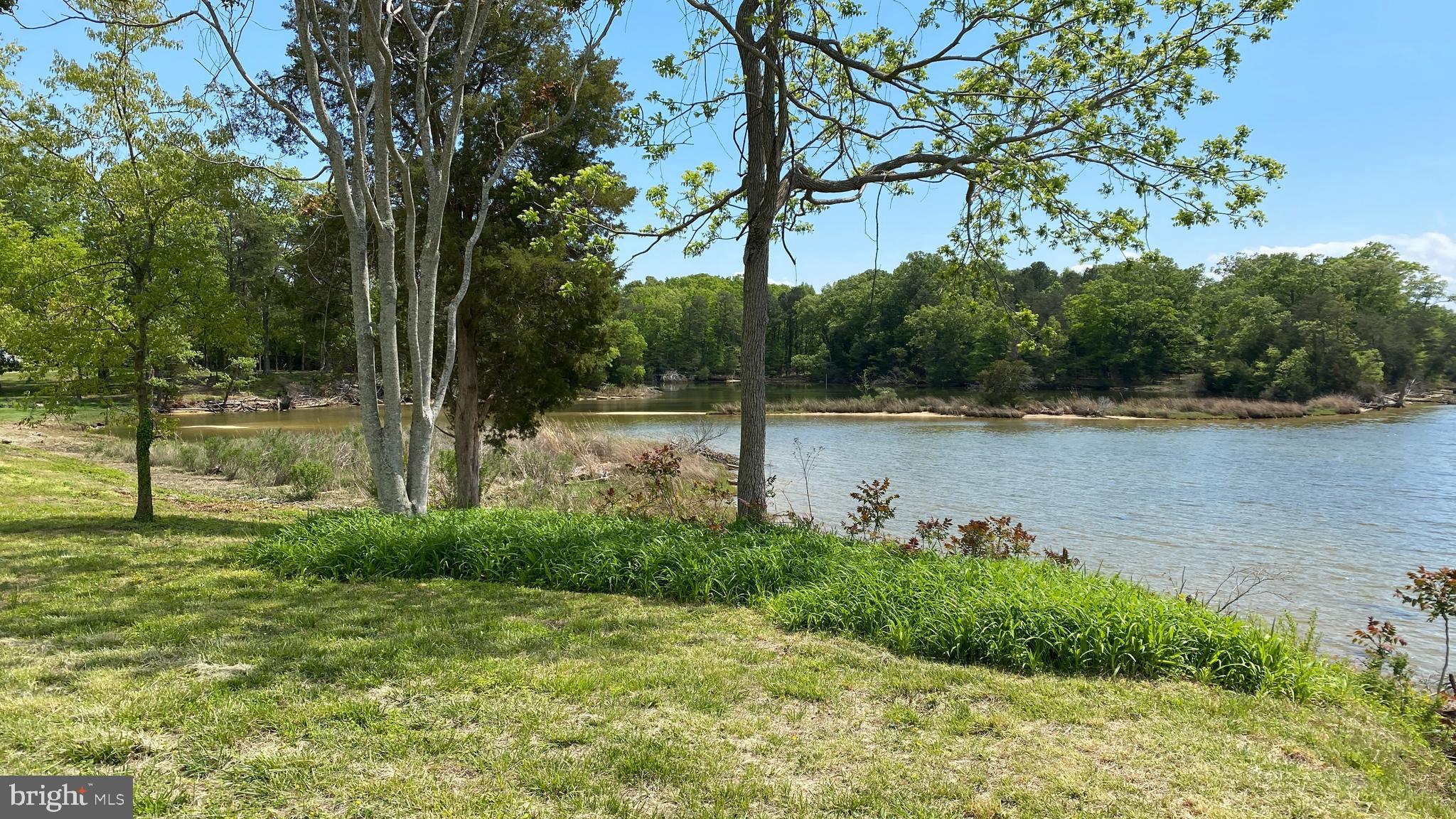 39645 Sweetpea Lane Leonardtown, MD 20650 - Photo 15 of 66 a backyard of a house with lots of green space and lake view