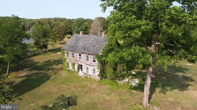 an aerial view of a houses with yard