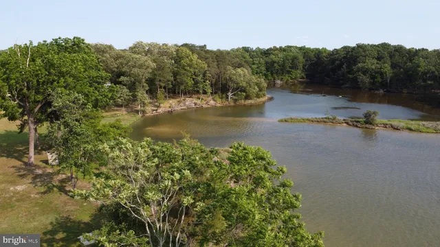 an aerial view of a residential houses with yard