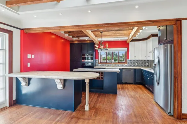 a kitchen with stainless steel appliances granite countertop a sink dishwasher and stove with wooden floor