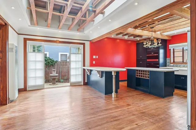 a kitchen with a table chairs and chandelier