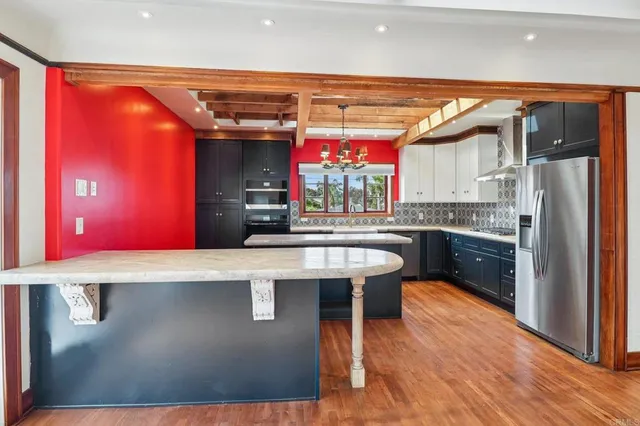 a kitchen with a sink cabinets and wooden floor