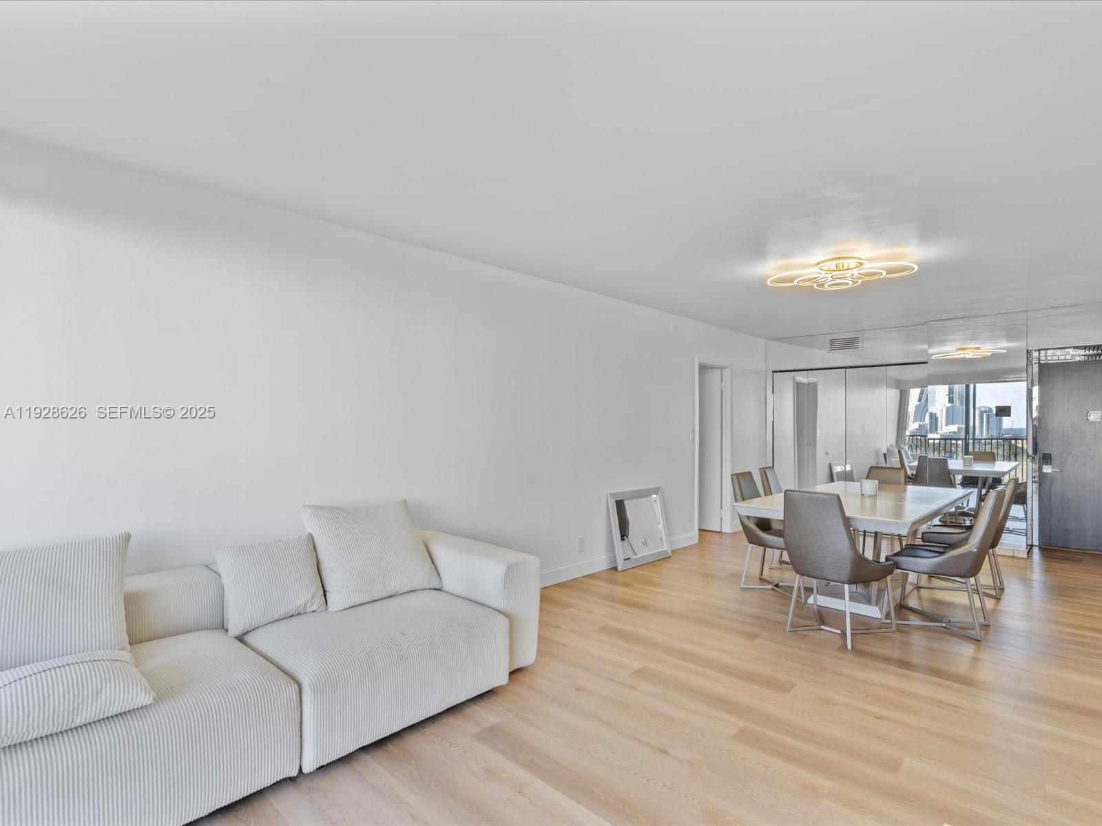 20335 West Country Club Drive, Unit 1608 Aventura, FL 33180 - Photo 11 of 26 a living room with furniture and a wooden floor