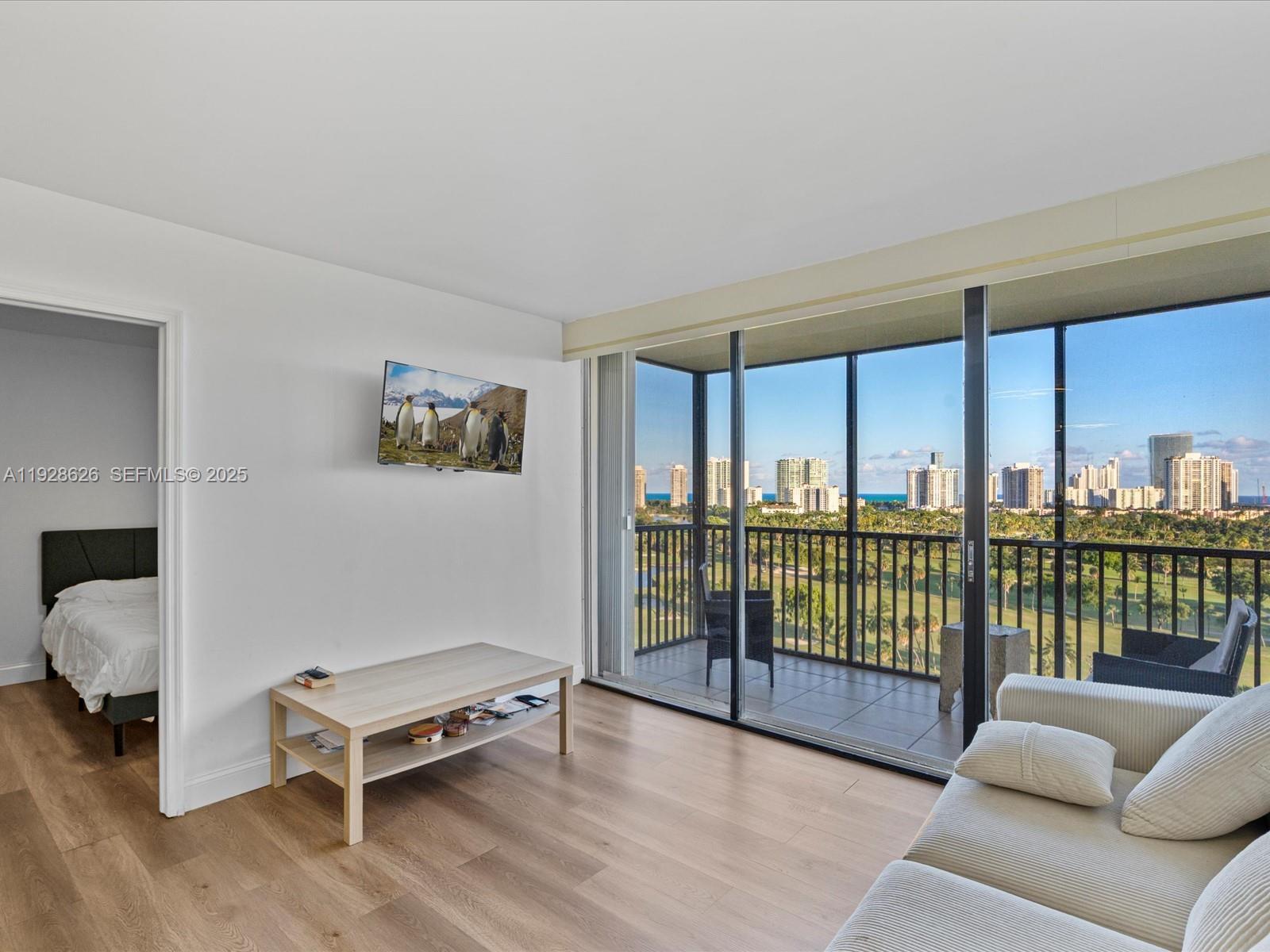 20335 West Country Club Drive, Unit 1608 Aventura, FL 33180 - Photo 14 of 26 a living room with furniture lamp and window