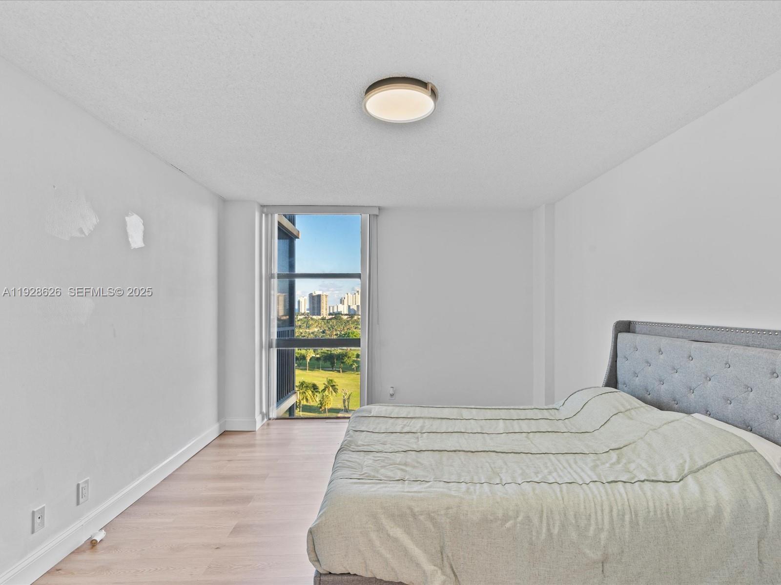 20335 West Country Club Drive, Unit 1608 Aventura, FL 33180 - Photo 16 of 26 a bedroom with a bed and a window