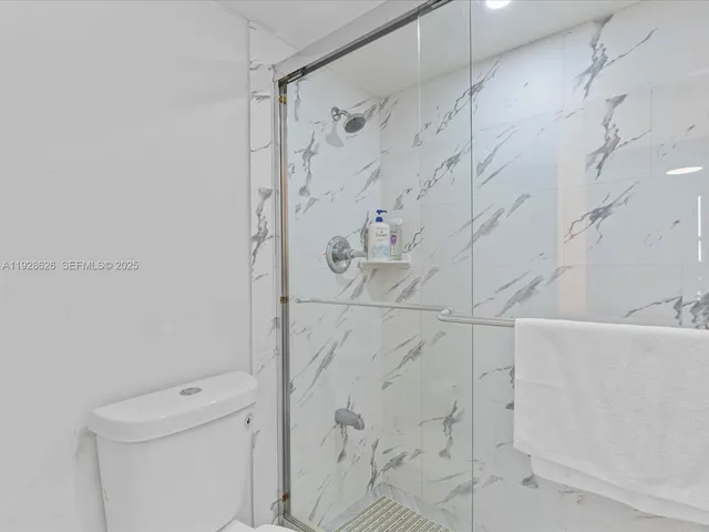 a bathroom with a shower and toilet