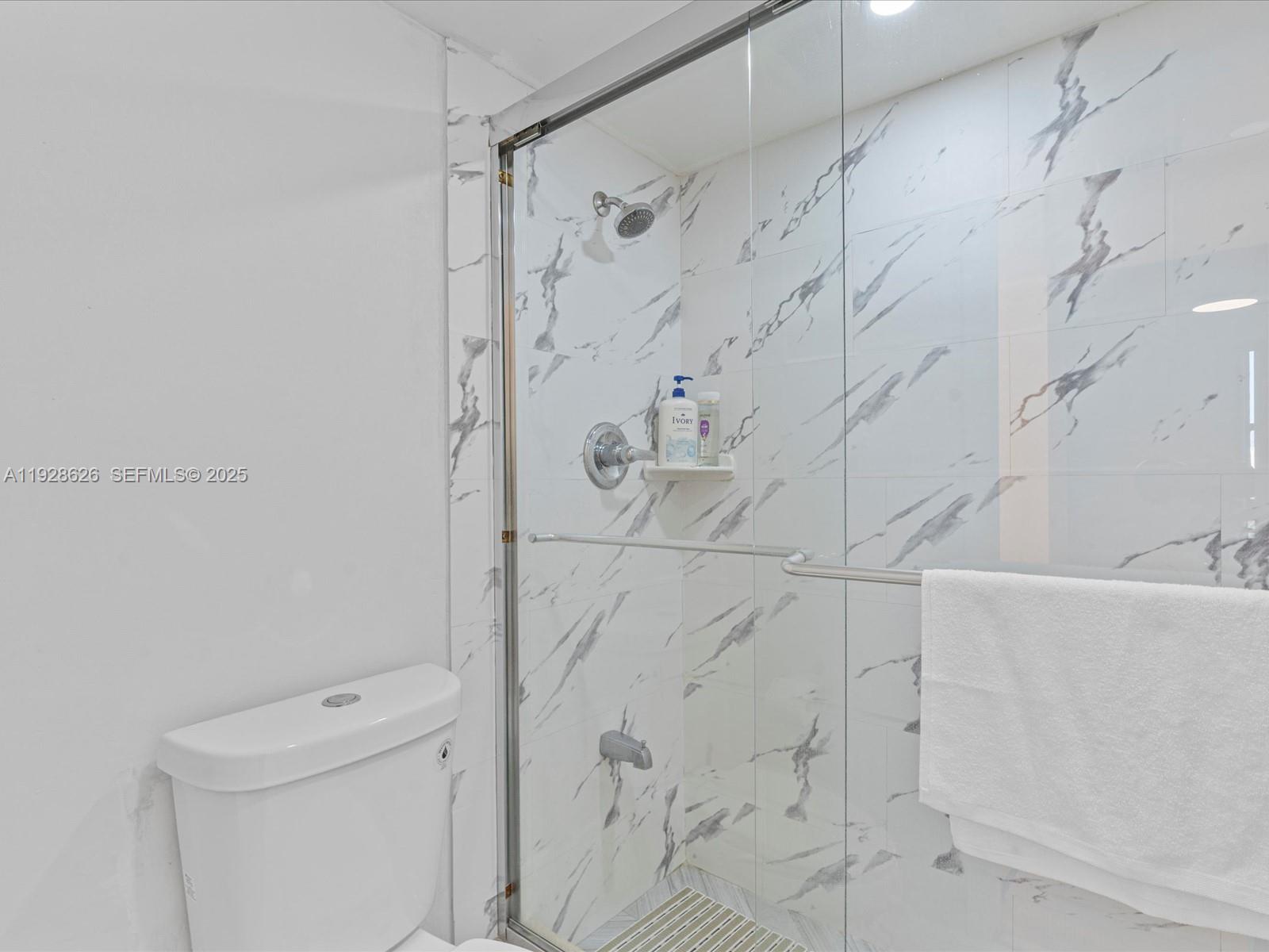 20335 West Country Club Drive, Unit 1608 Aventura, FL 33180 - Photo 19 of 26 a bathroom with a shower and toilet