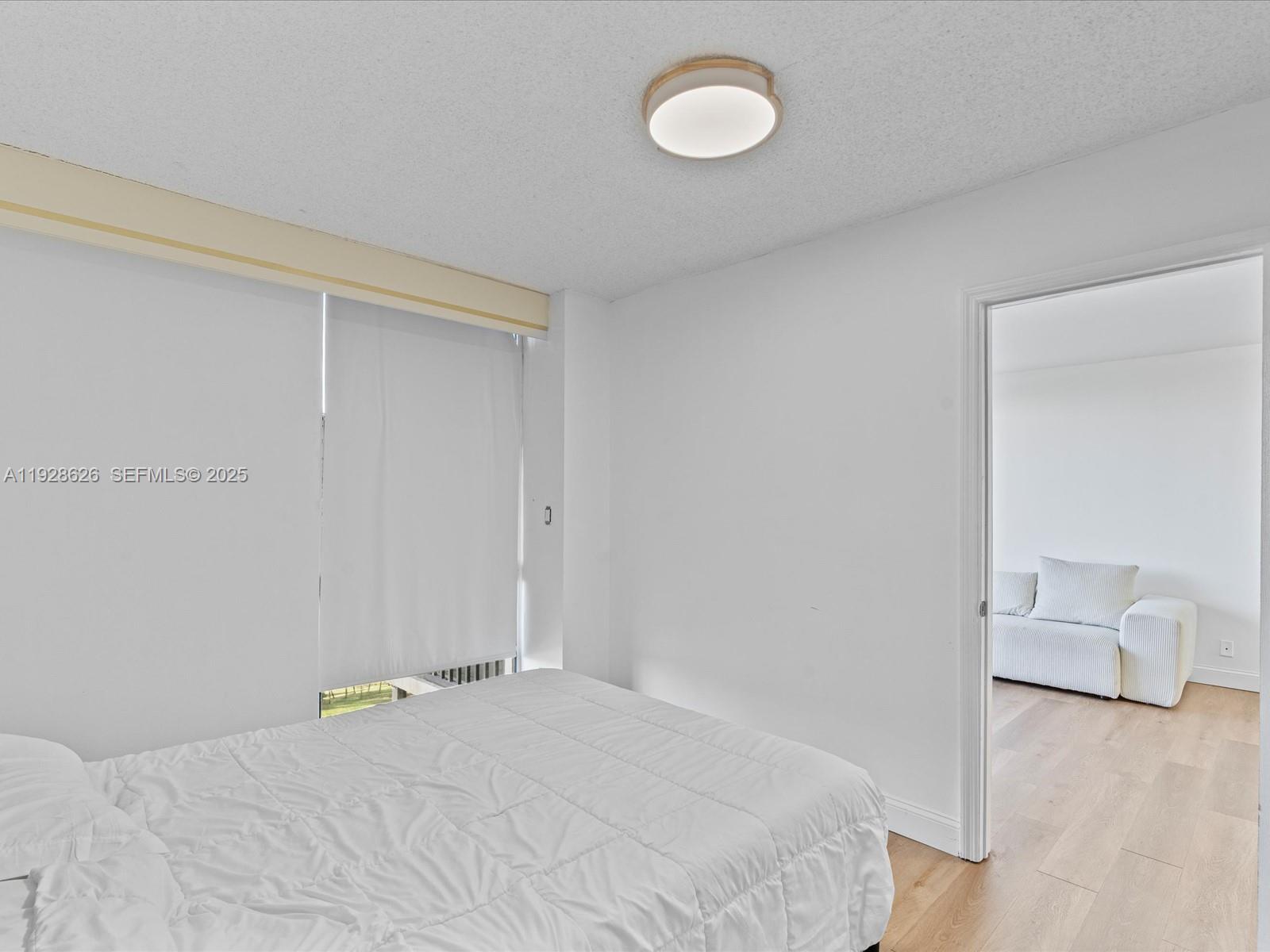 20335 West Country Club Drive, Unit 1608 Aventura, FL 33180 - Photo 20 of 26 a bedroom with a bed and a chair