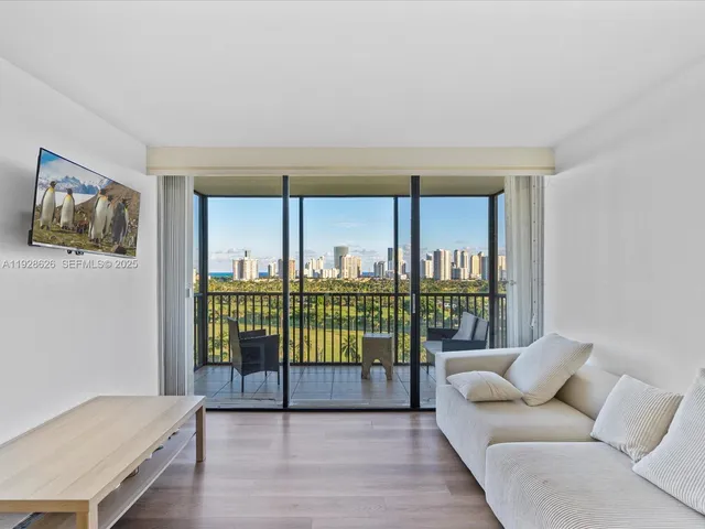 a living room with a couch a table and a large window