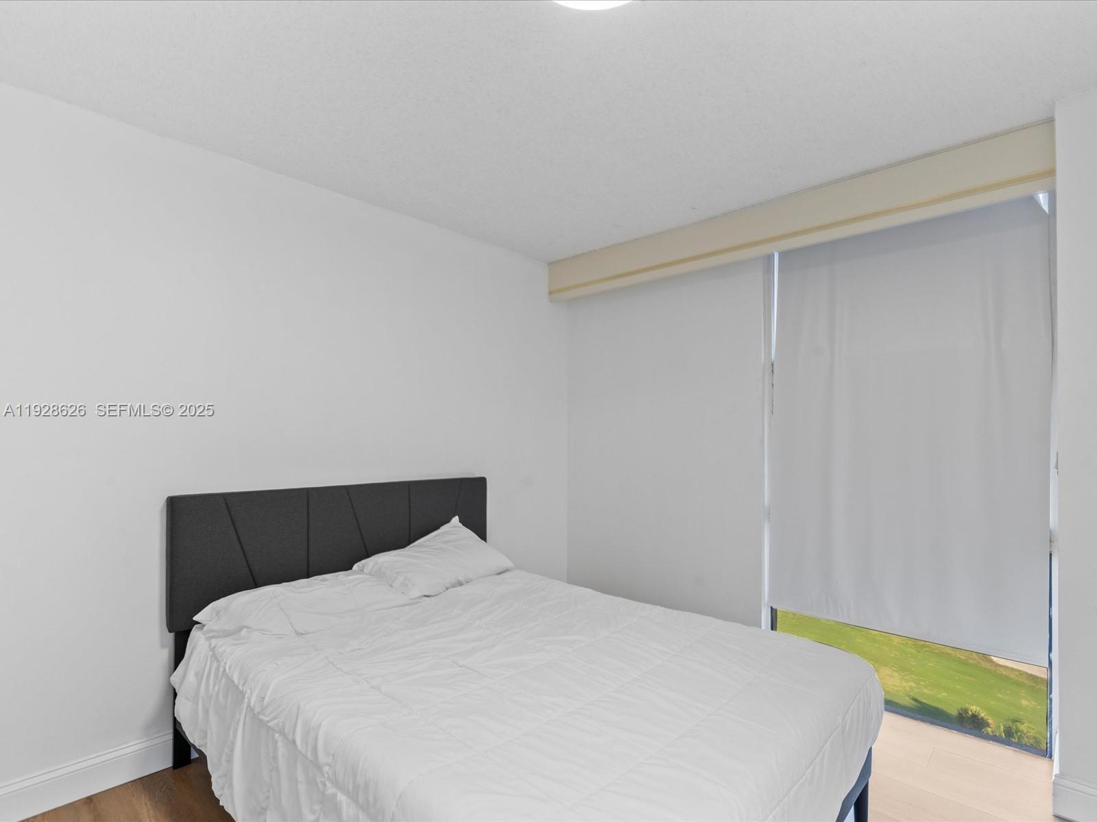 20335 West Country Club Drive, Unit 1608 Aventura, FL 33180 - Photo 21 of 26 a bedroom with a bed and a night stand