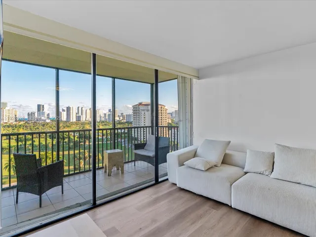a living room with furniture and a floor to ceiling window