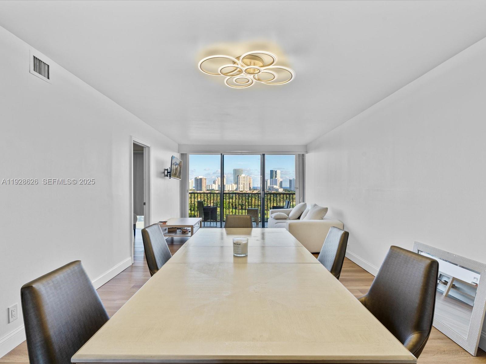 20335 West Country Club Drive, Unit 1608 Aventura, FL 33180 - Photo 5 of 26 a living room with furniture and a large window