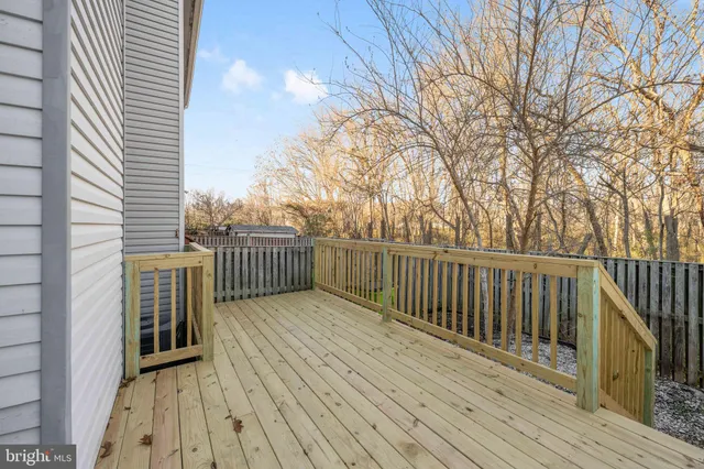 a balcony with wooden floor and fence