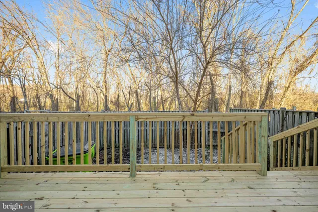 a view of balcony with wooden fence and floor