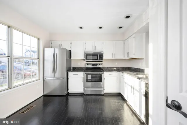 a kitchen with stainless steel appliances a refrigerator stove and sink