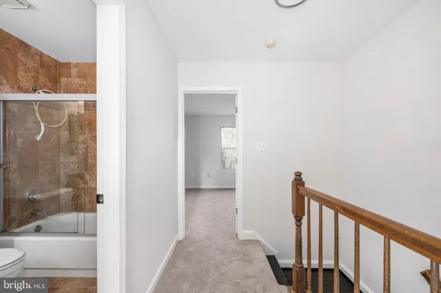 a view of a hallway with a shower