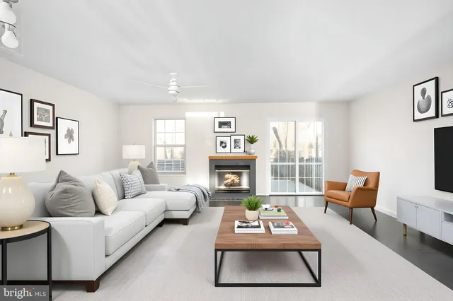a living room with furniture fireplace and window