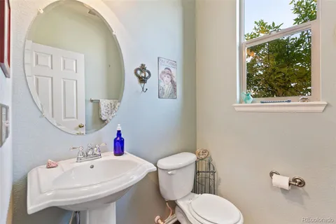 a white toilet sitting next to a bathroom sink
