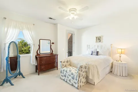 a bedroom with a bed chair and window