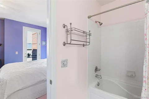 a bathroom with a bathtub and a shower