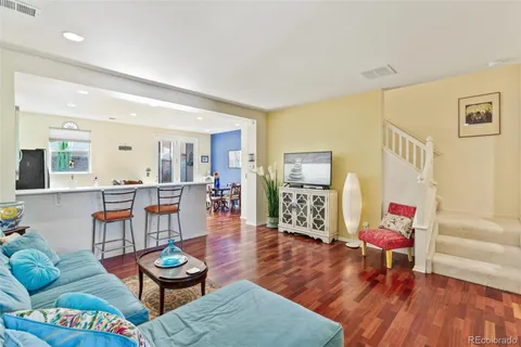 a living room with furniture and wooden floor
