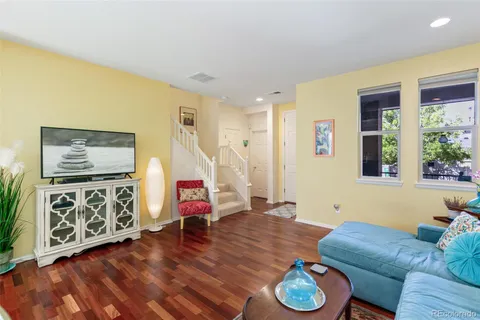 a living room with furniture and wooden floor
