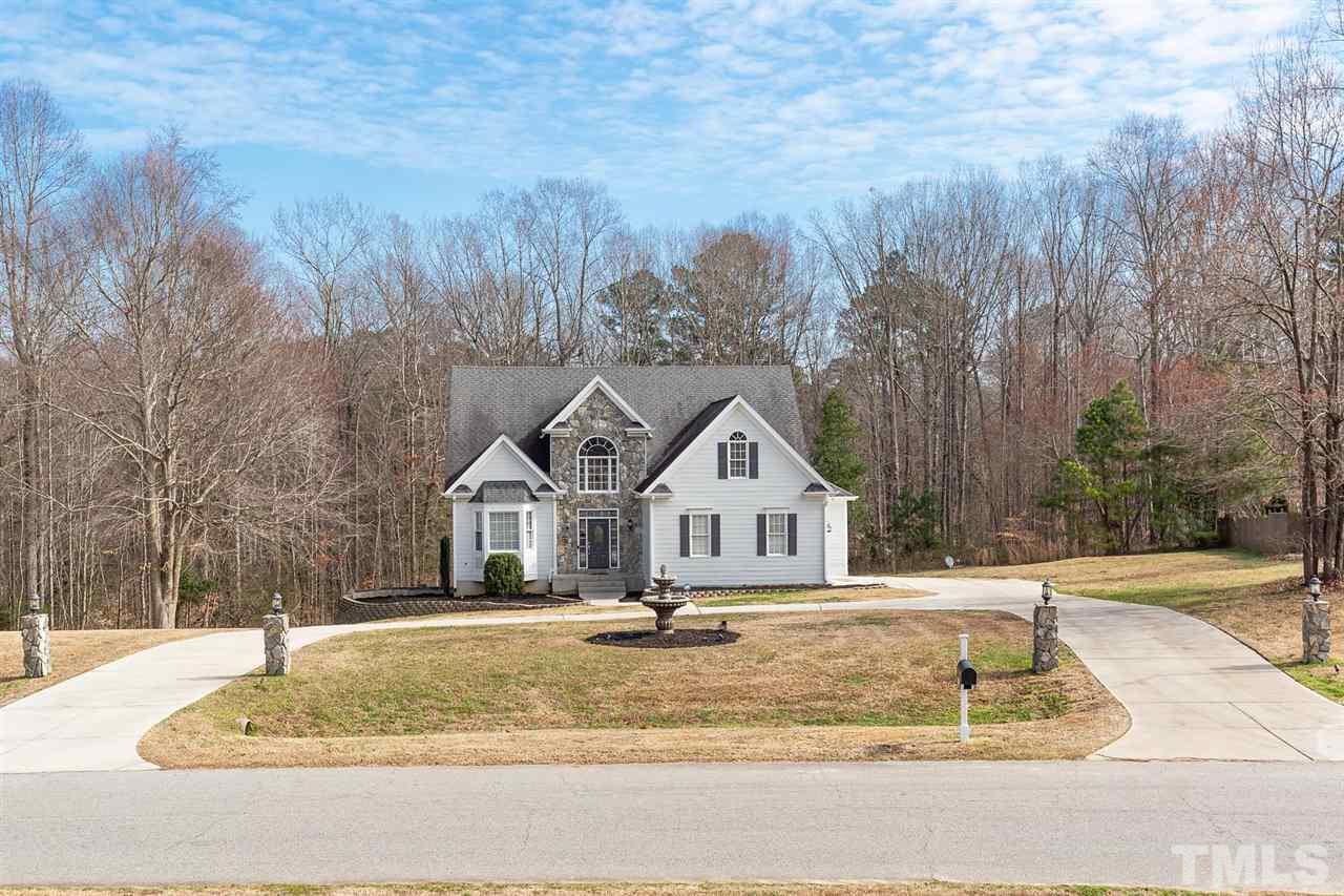 4401 Irene Way Raleigh, NC 27603 - Photo 2 of 30 Beautiful fountain feature in front, circular drive, parking pad, and 2-car side load garage.