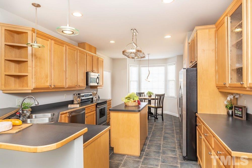 4401 Irene Way Raleigh, NC 27603 - Photo 5 of 30 Kitchen open to separate Dining Area, and Breakfast Nook w/bay windows and lots of natural light.