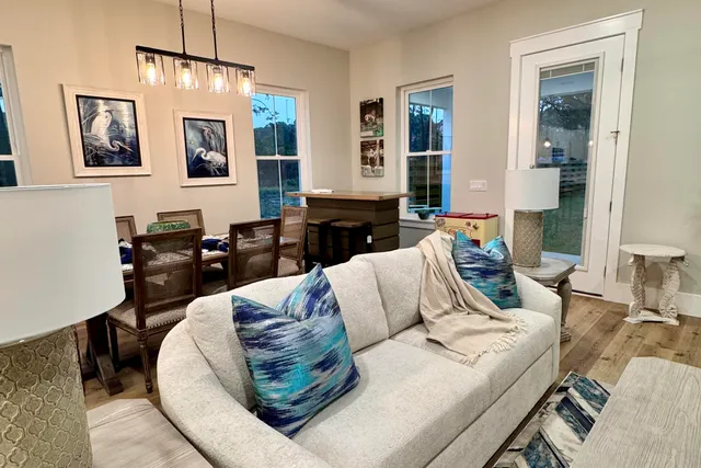 a living room with furniture or couch and a chandelier