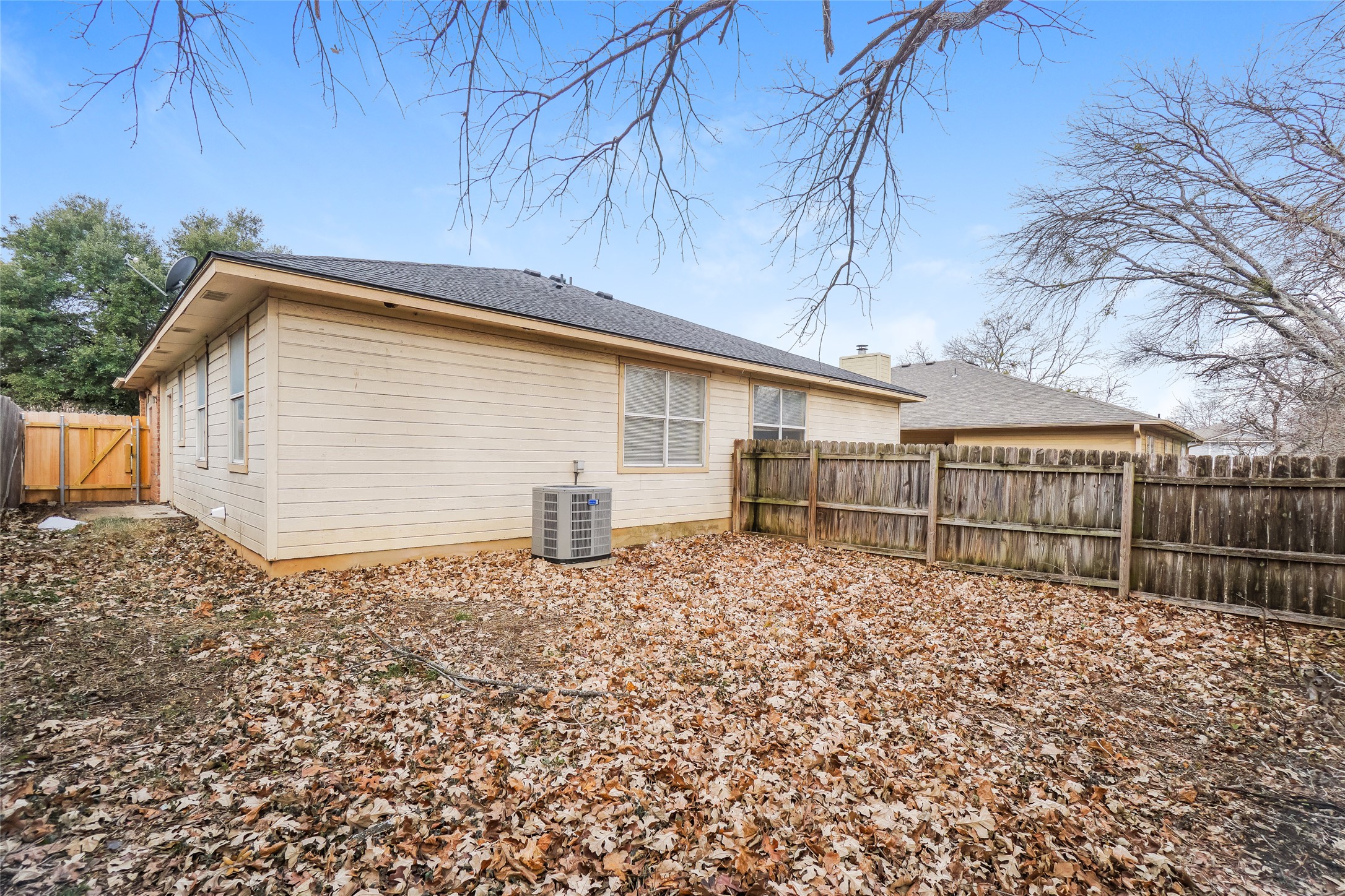 2403 Curry Loop Round Rock, TX 78664 - Photo 16 of 16 Back of property featuring a fenced backyard and a gate