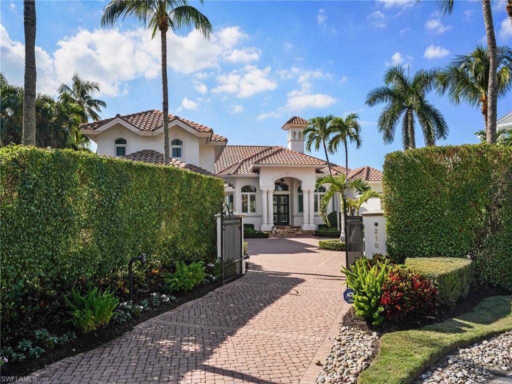 216 Springline Drive Naples, FL 34102 - Photo 14 of 46 Mediterranean / spanish house with decorative driveway, stucco siding, a gate, and a tile roof