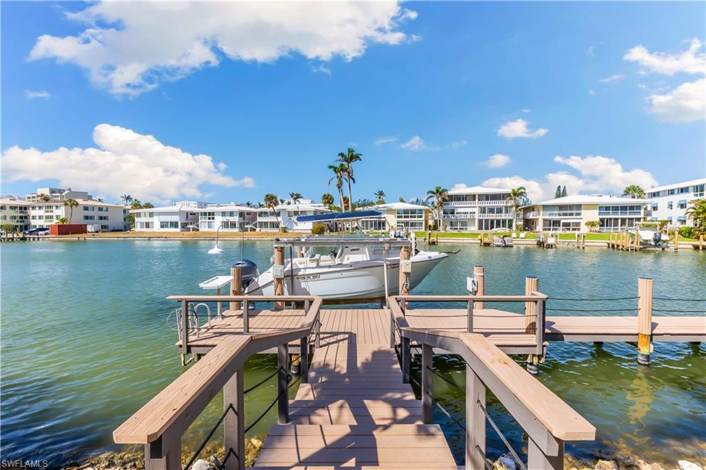 216 Springline Drive Naples, FL 34102 - Photo 37 of 46 Dock area with a water view, boat lift, and a residential view