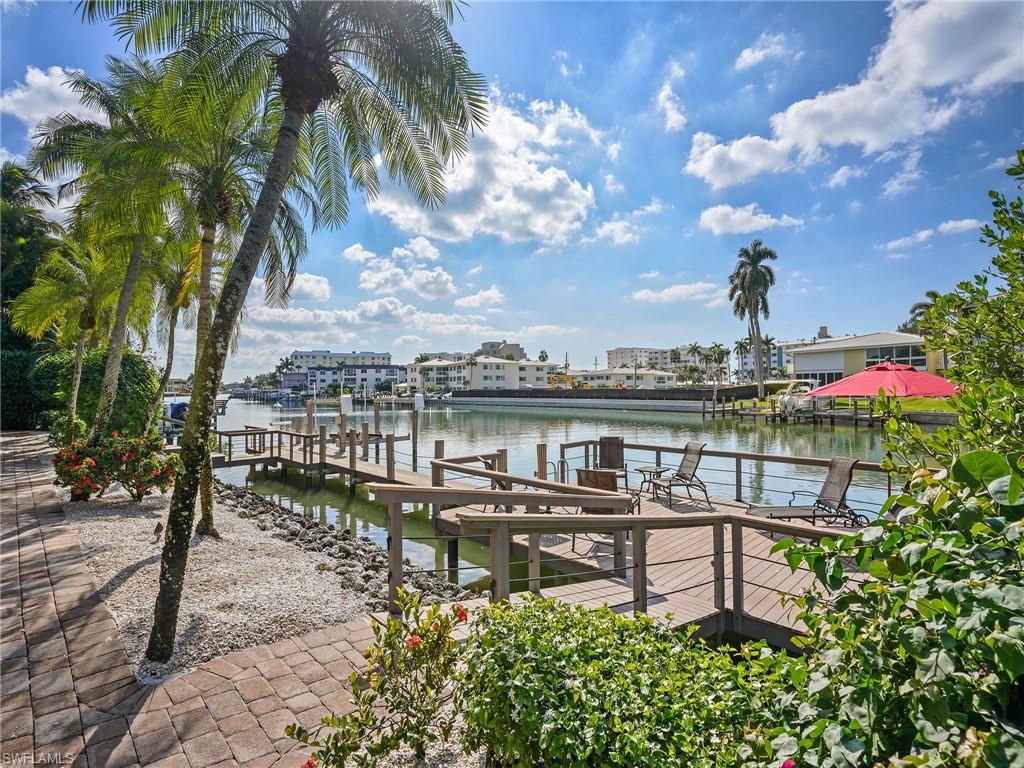 216 Springline Drive Naples, FL 34102 - Photo 39 of 46 Dock with boat lift and a water view
