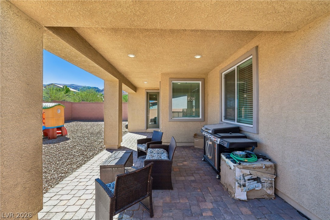 194 Viento Ridge Street Henderson, NV 89012 - Photo 53 of 72 Recessed lighting illuminates this covered patio area overlooking the back yard.