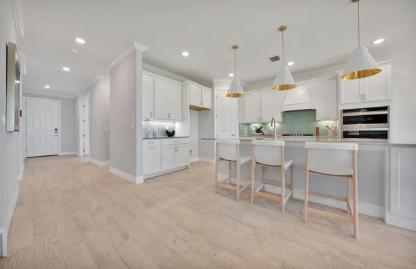 a very nice looking living room with a large window and kitchen view