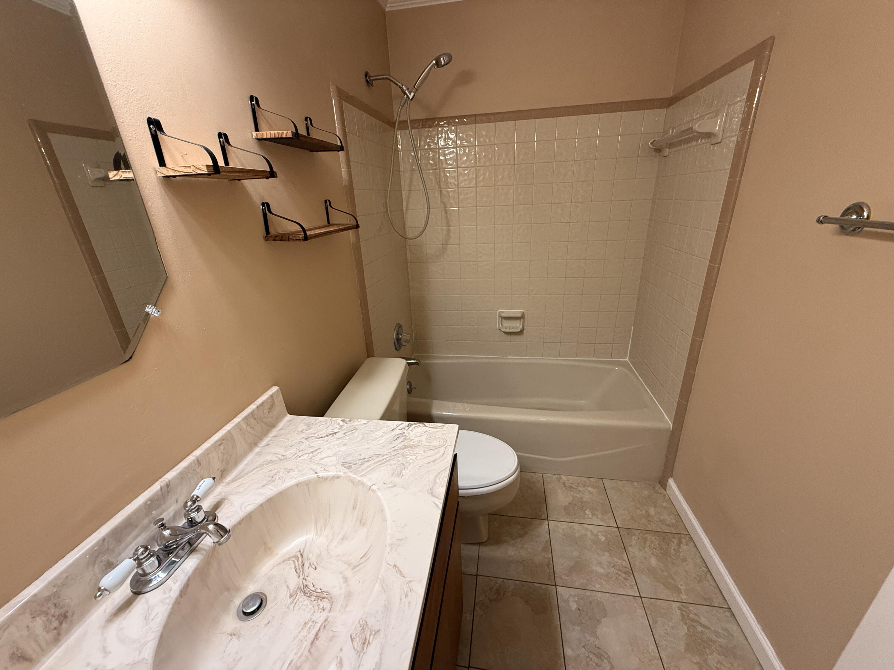 1054 9th Street Shalimar, FL 32579 - Photo 22 of 45 a bathroom with a bathtub and a shower