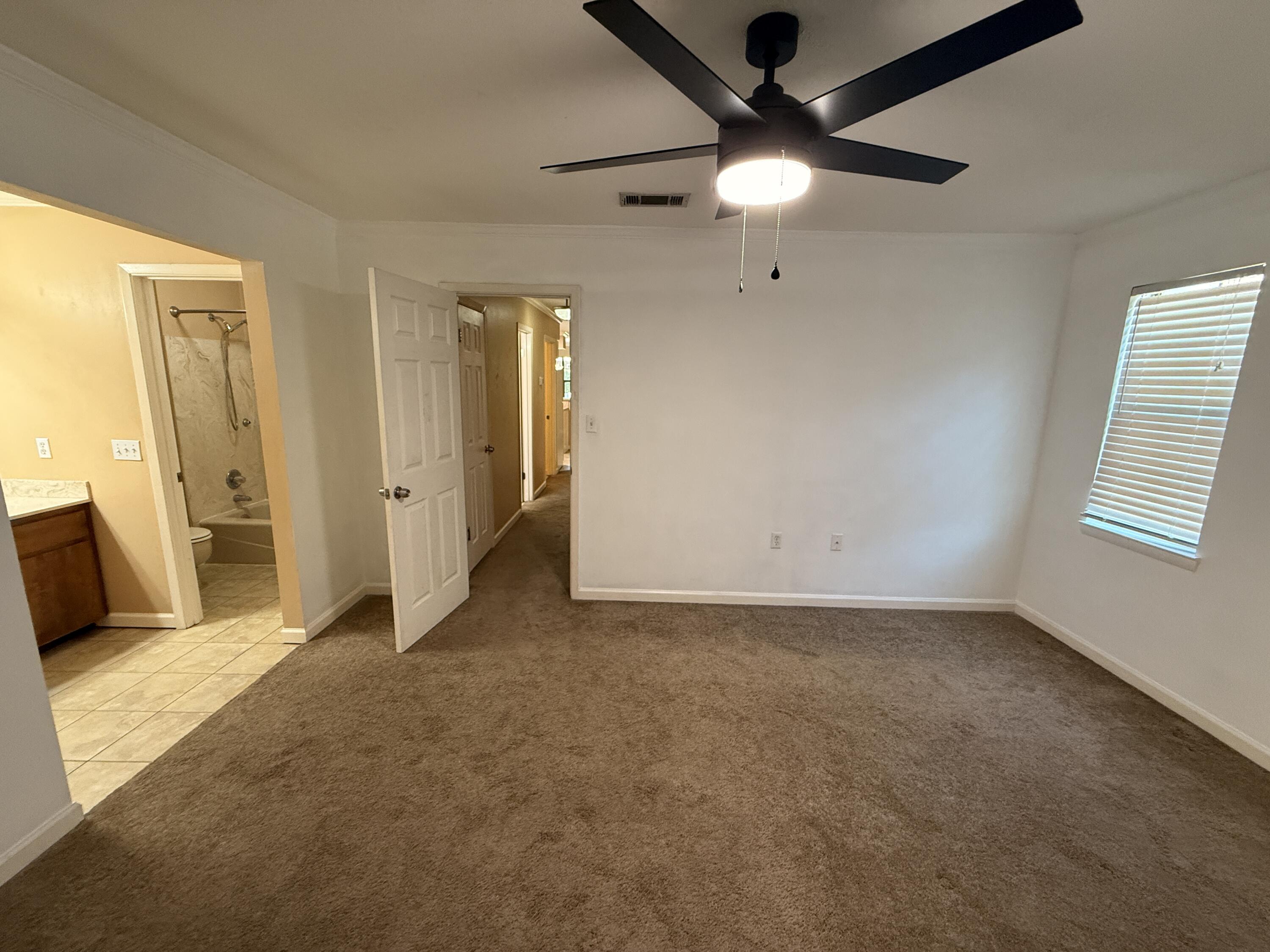 1054 9th Street Shalimar, FL 32579 - Photo 25 of 45 an empty room with closet and a ceiling fan