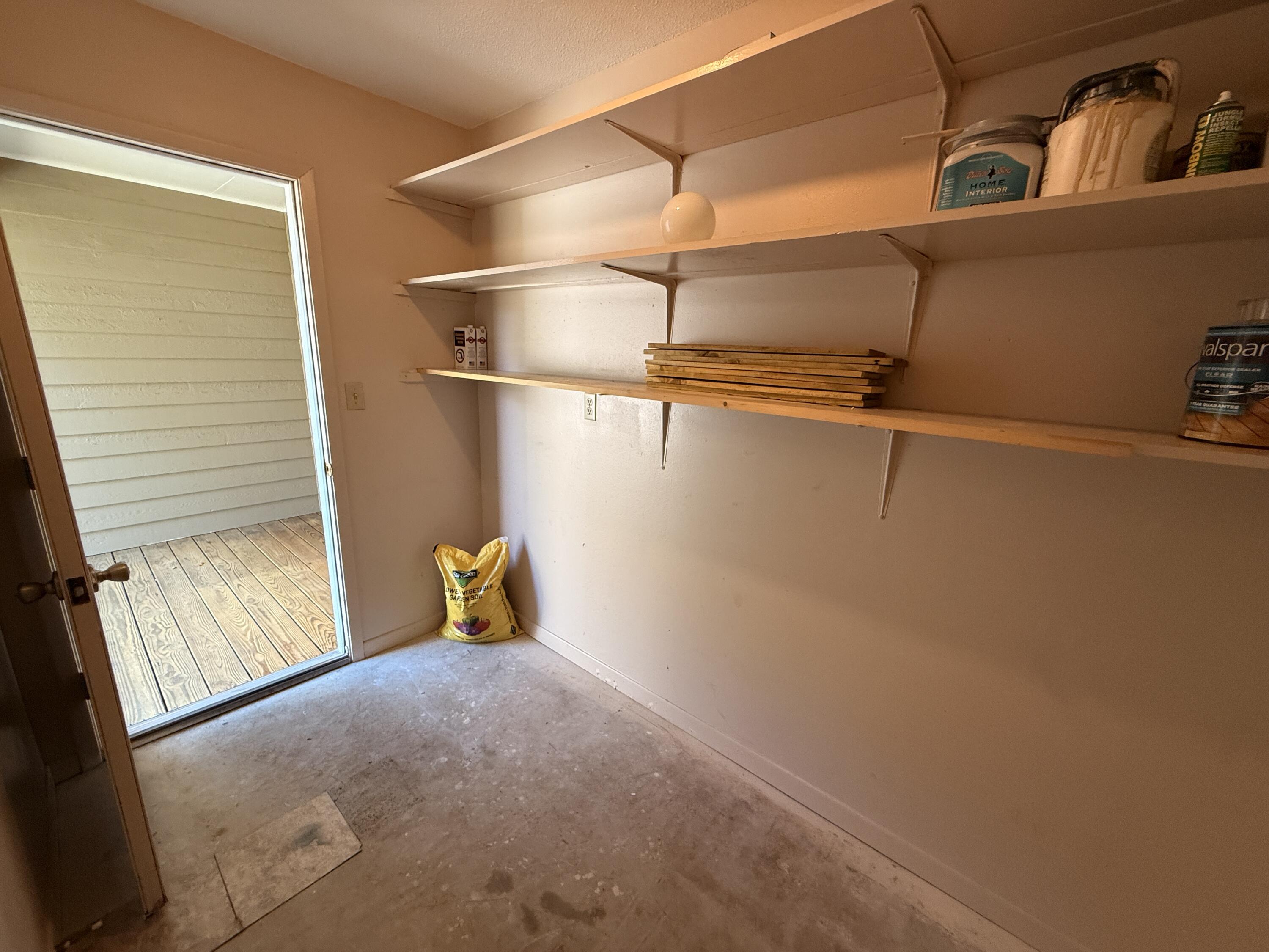 1054 9th Street Shalimar, FL 32579 - Photo 41 of 45 a view of storage and utility room with racks on the wall