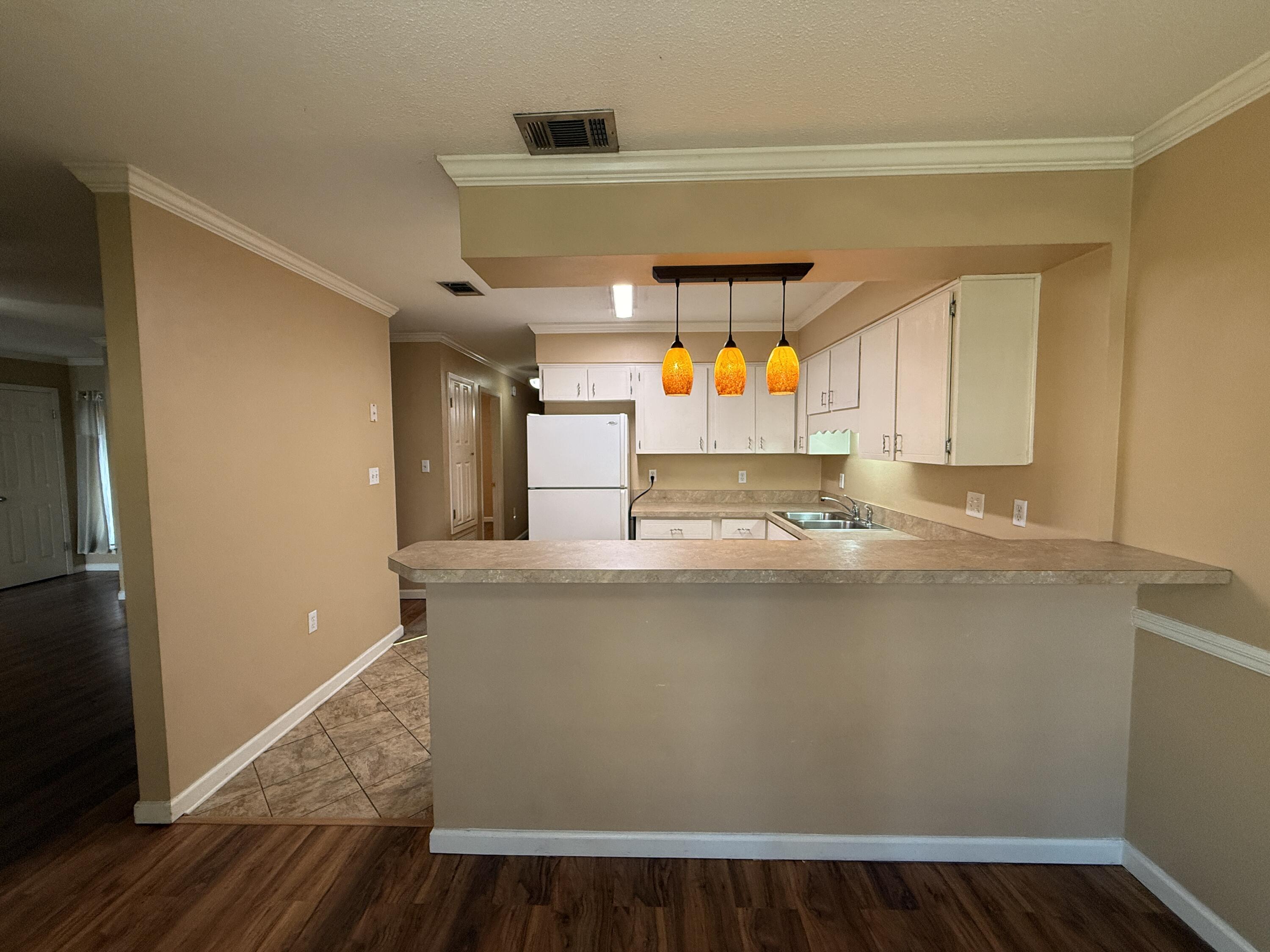 1054 9th Street Shalimar, FL 32579 - Photo 7 of 45 a room with wooden floors and stainless steel appliances