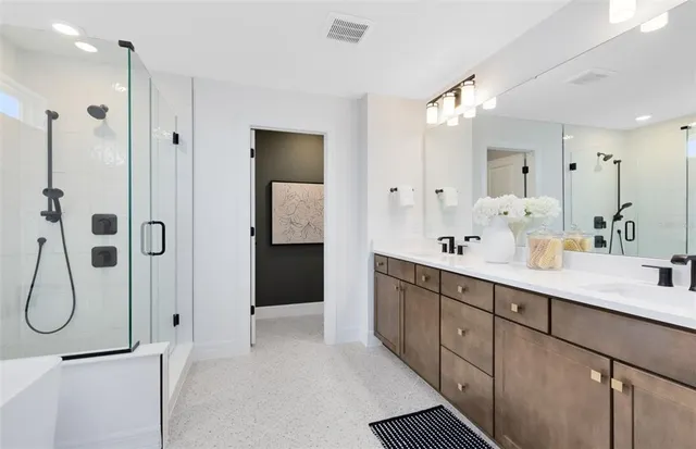 a spacious bathroom with a shower sink double and mirror