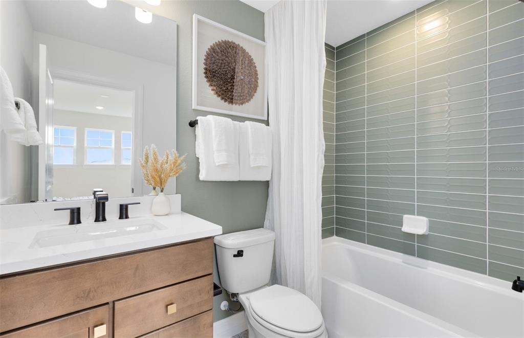 9821 Autumn Rdg Avenue Riverview, FL 33578 - Photo 15 of 30 a bathroom with a sink a toilet and shower