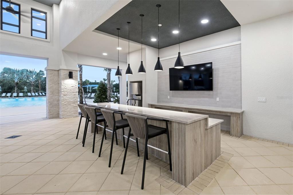 9821 Autumn Rdg Avenue Riverview, FL 33578 - Photo 27 of 30 a kitchen with stainless steel appliances kitchen island granite countertop a dining table chairs and a refrigerator