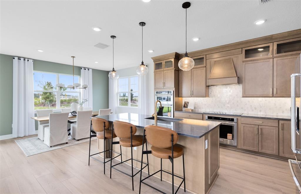 9821 Autumn Rdg Avenue Riverview, FL 33578 - Photo 3 of 30 a kitchen with granite countertop a sink cabinets and stainless steel appliances