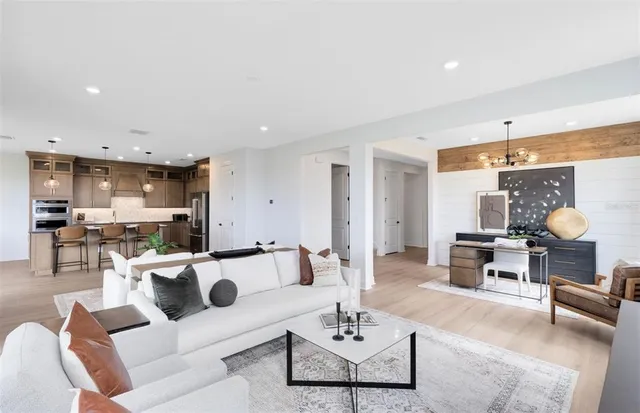 a living room with furniture kitchen view and a table