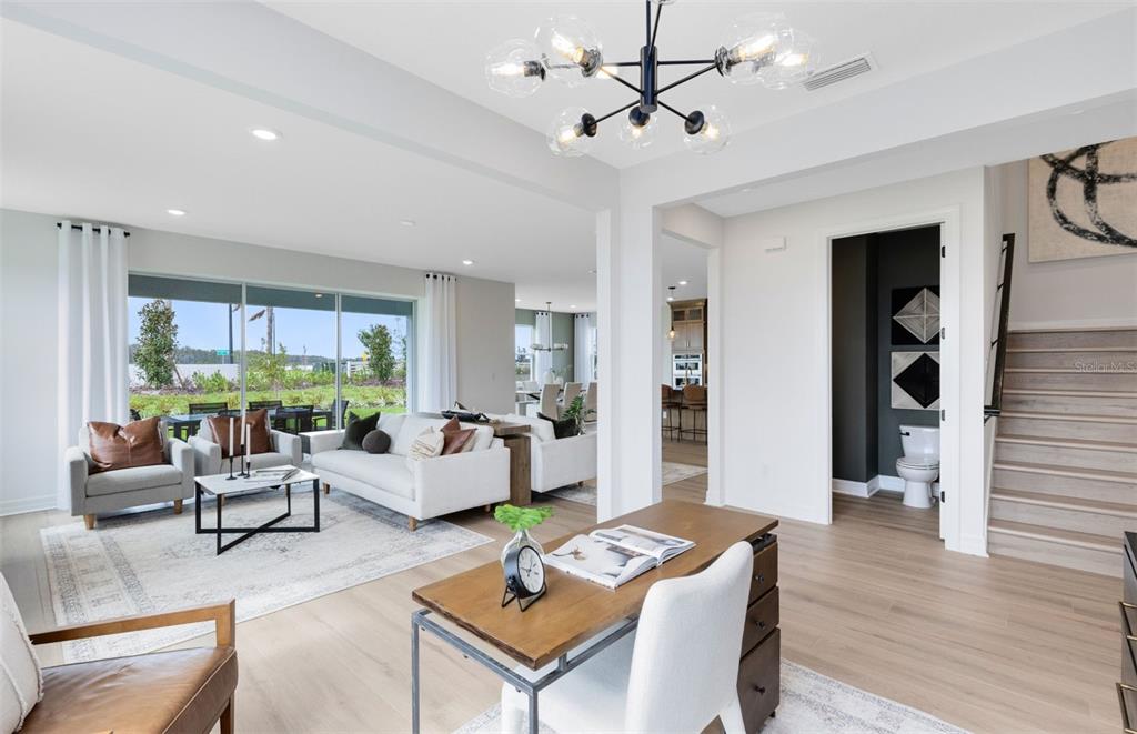 9821 Autumn Rdg Avenue Riverview, FL 33578 - Photo 6 of 30 a living room with furniture a table and wooden floor