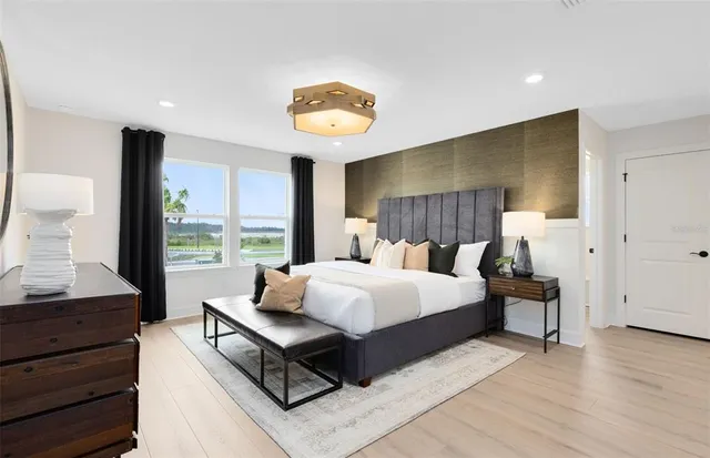 a bed room with a bed and a lamp