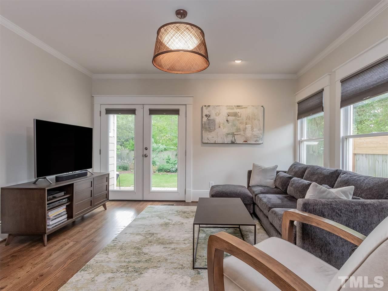 2215 The Circle Raleigh, NC 27608 - Photo 15 of 30 a living room with furniture and a flat screen tv