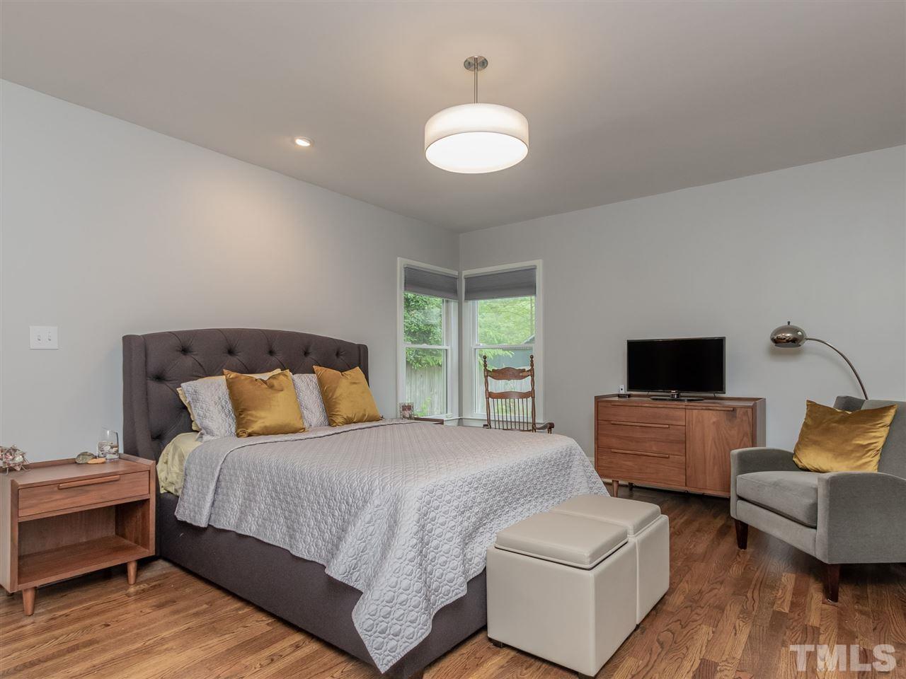 2215 The Circle Raleigh, NC 27608 - Photo 17 of 30 a bedroom with bed and wooden floor