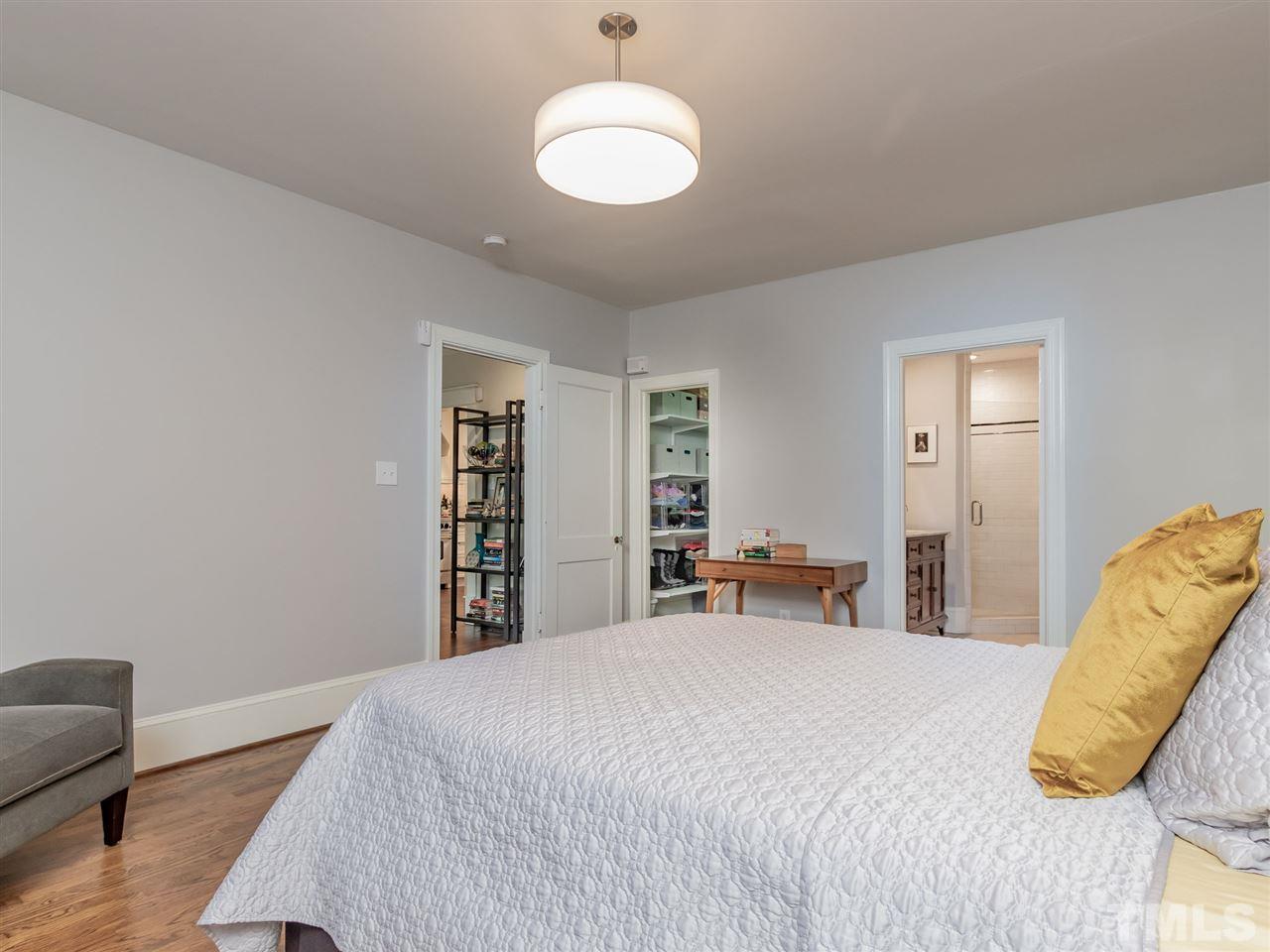 2215 The Circle Raleigh, NC 27608 - Photo 18 of 30 a bedroom with a bed and a couch