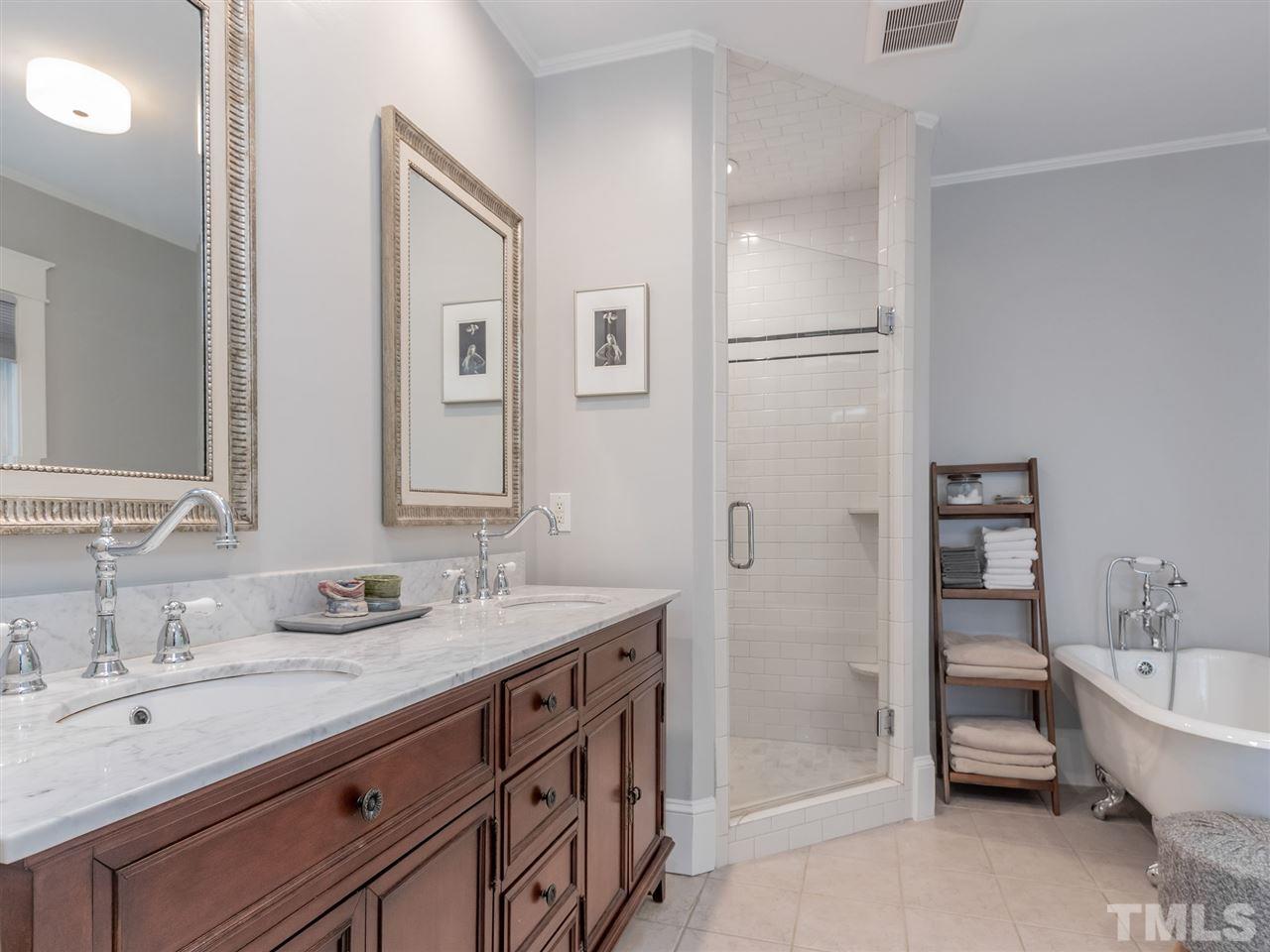 2215 The Circle Raleigh, NC 27608 - Photo 19 of 30 a bathroom with a tub sink and mirror